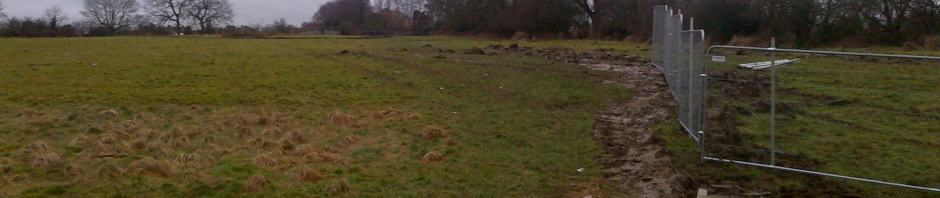 A view of Codnor Common that is still undeveloped, a bridge and stile points towards Ripley